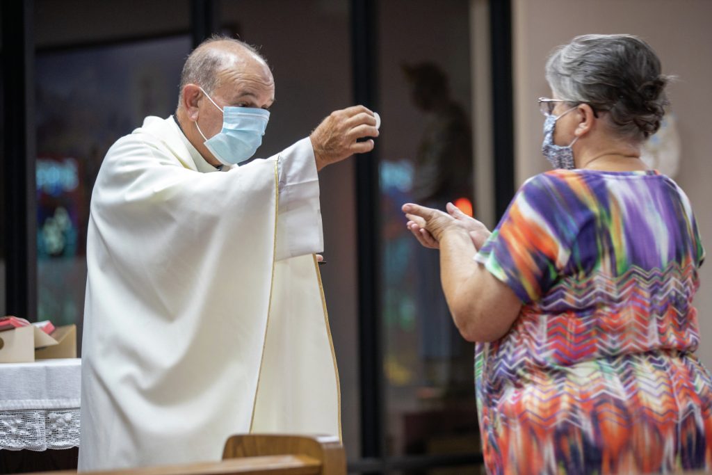 fr-ron-foshage-giving-communion-during-pandemic