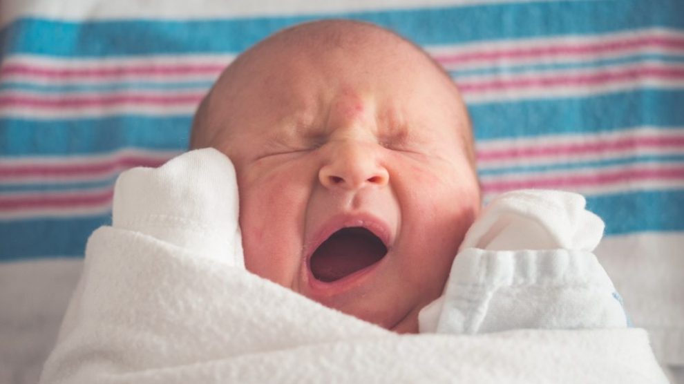 baby-yawning-swaddled-in-blanket