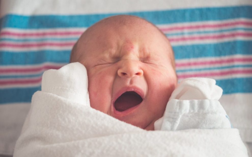 baby-yawning-swaddled-in-blanket