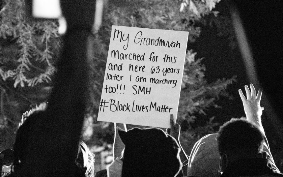 people-holding-up-black-lives-matter-sign-at-protest