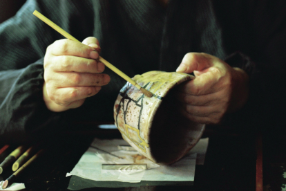 man-using-kintsugi-to-repair-a-broken-bowl