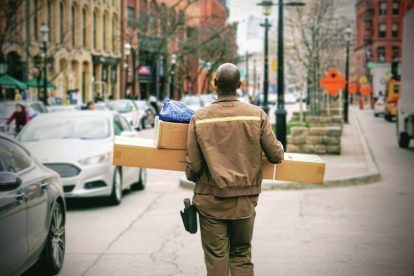 worker-carrying-packages-on-sidewalk