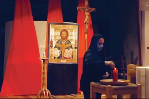 woman-lighting-a-candle-for-taize-prayer