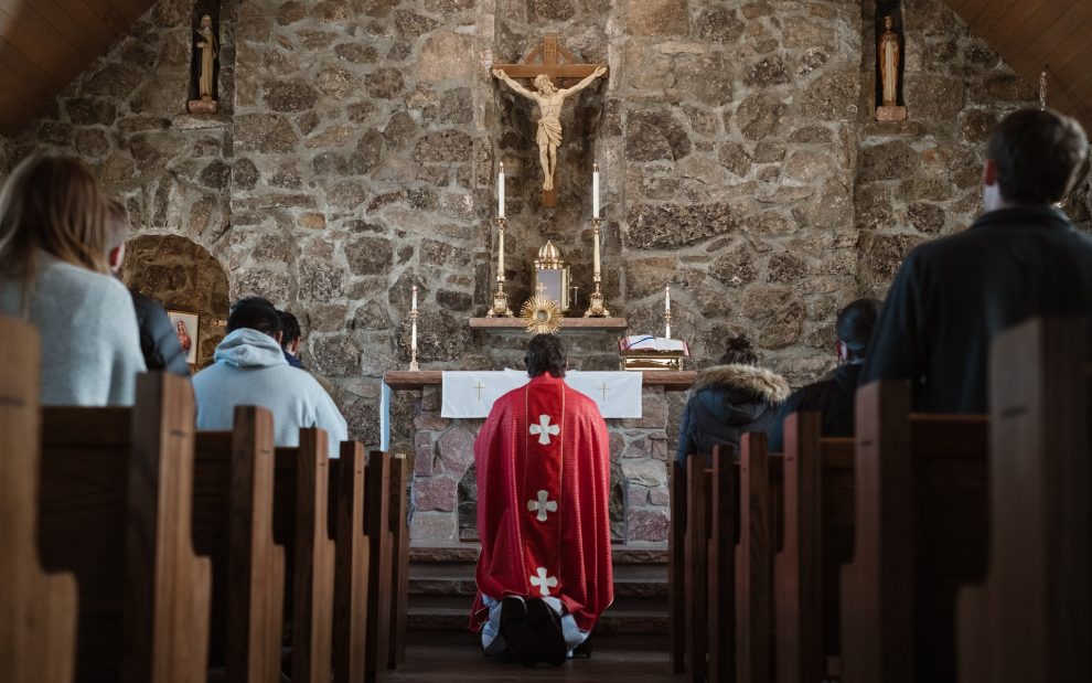 priest-kneeling-before-altar