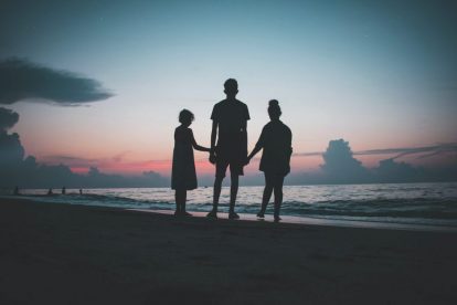 silhouette-of-three-people-standing-on-a-beach