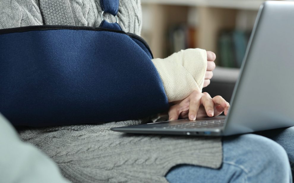woman-at-computer-with-broken-arm