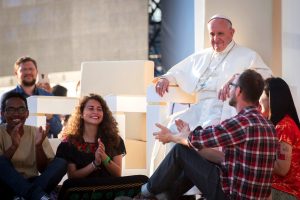 pope-francis-sits-with-a-group-of-young-people