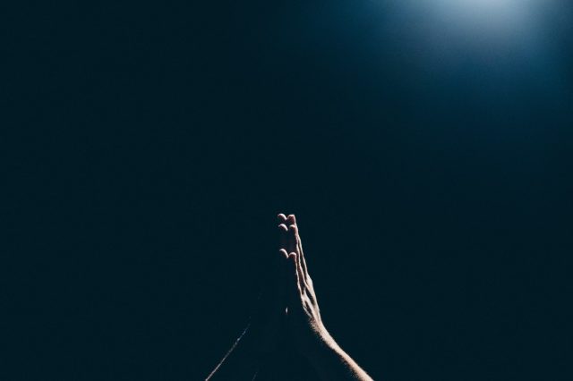 person-raising-hands-in-prayer