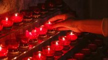 lighting-votive-candle-in-church