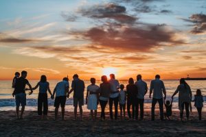 large-family-watching-sunset-at-beach