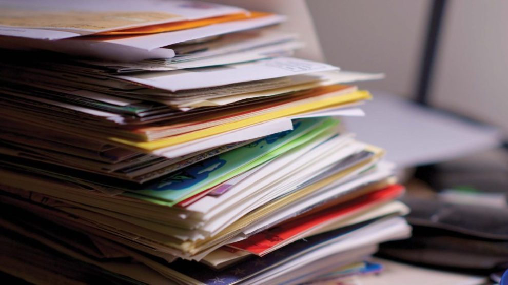 stack-of-surveys-and-envelopes