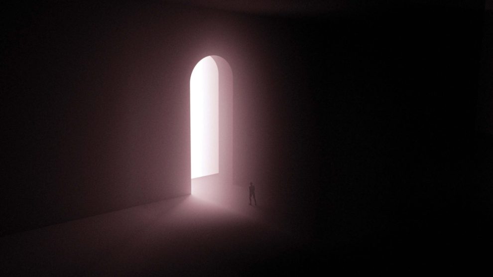 person-walking-through-a-door-from-darkness-into-light