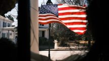 american-flag-hanging-from-house