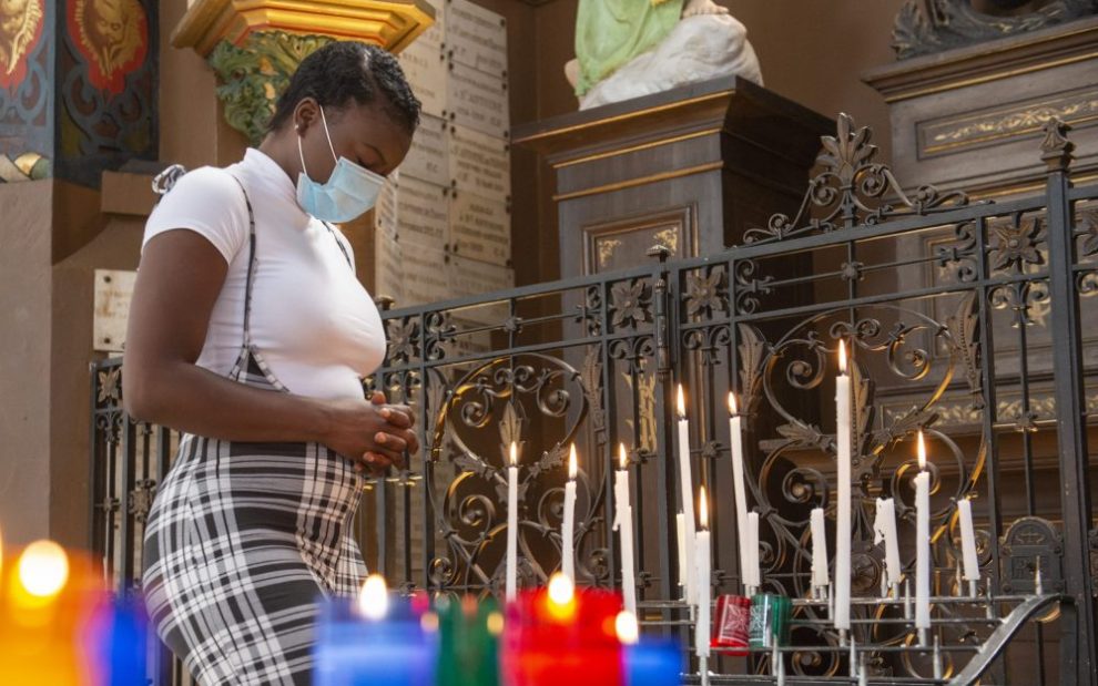 black-woman-praying-in-front-of-candles