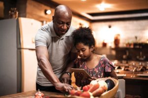 father-and-daughter-preparing-meal-together