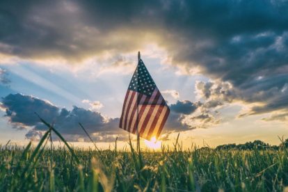 american-flag-in-field-at-sunset