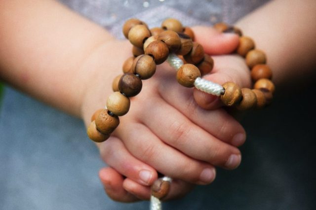 hands-holding-a-rosary