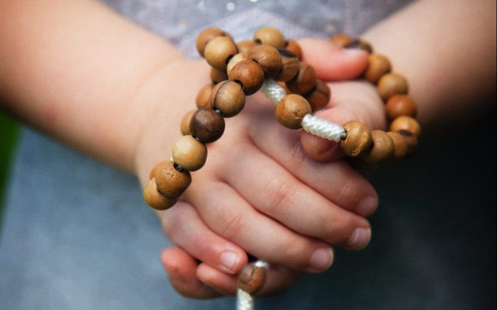 hands-holding-a-rosary