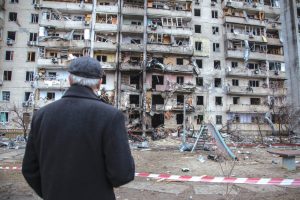 man-in-ukraine-standing-in-war-torn-city