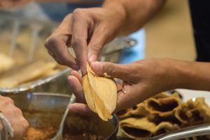 person-wrapping-tamales