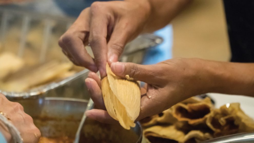 person-wrapping-tamales
