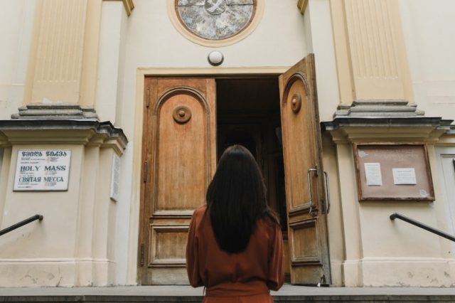 woman-standing-outside-church-entrance