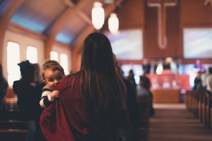 mother-holding-child-in-church-pew