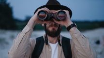 man-looking-through-binoculars