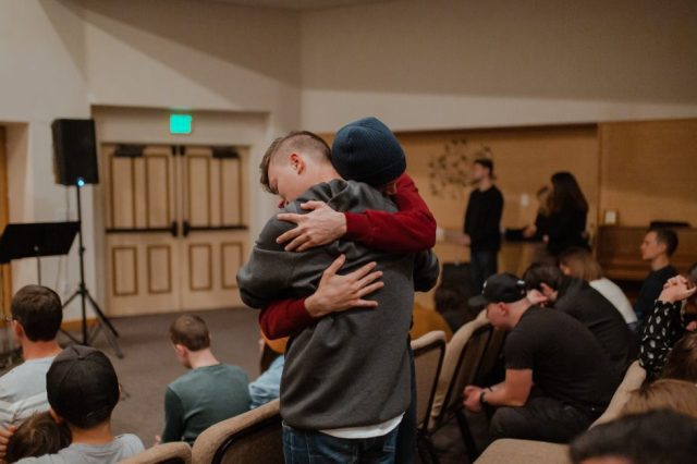 two-men-hugging-in-men's-group