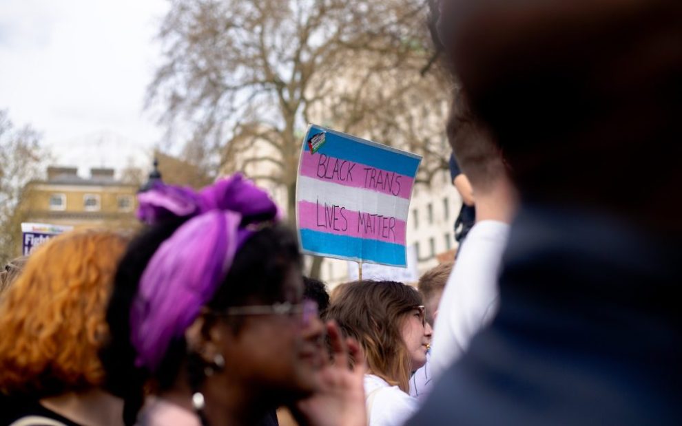 crowd-of-people-standing-with-trans-flag-sign