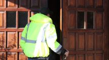 man-in-safety-jacket-entering-church