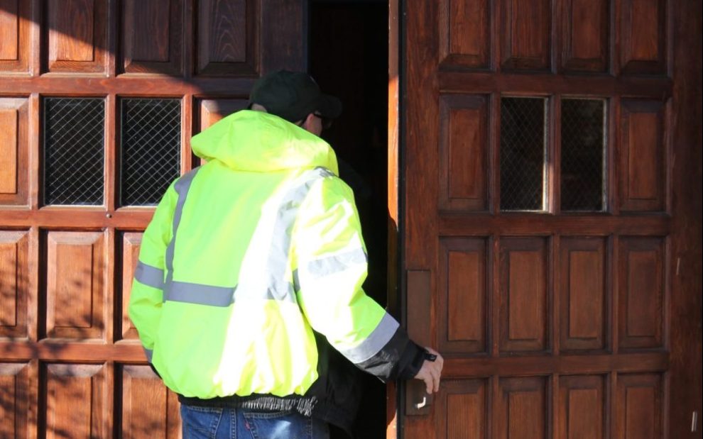 man-in-safety-jacket-entering-church