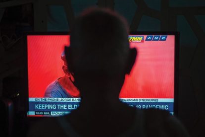 silhouette-of-person-watching-news-on-tv