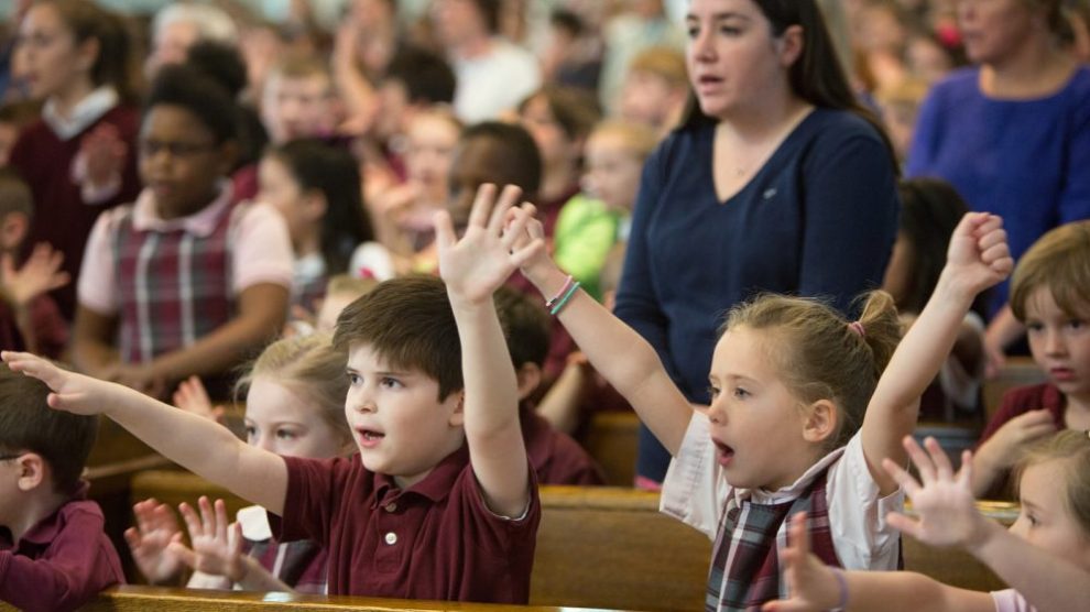children-in-catholic-school-uniforms-cheering