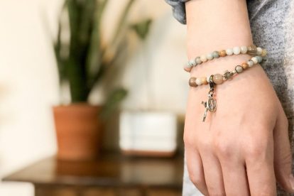 woman-wearing-bracelet-with-cross-and-miraculous-medal