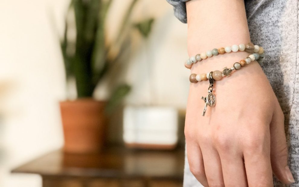 woman-wearing-bracelet-with-cross-and-miraculous-medal