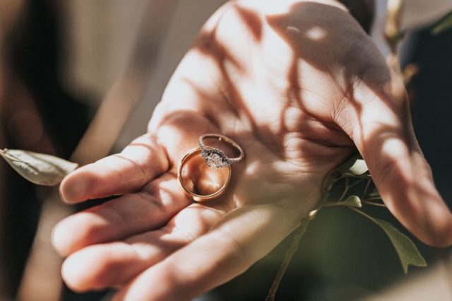 hand-holding-wedding-bands