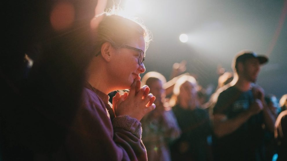 young-woman-praying-in-crowd