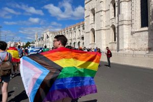 man-carries-pride-flag-at-world-youth-day