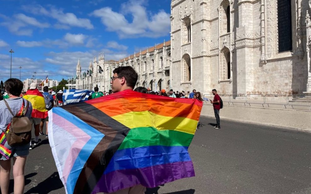 man-carries-pride-flag-at-world-youth-day