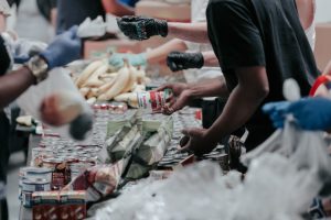 people-handing-out-food-at-food-bank