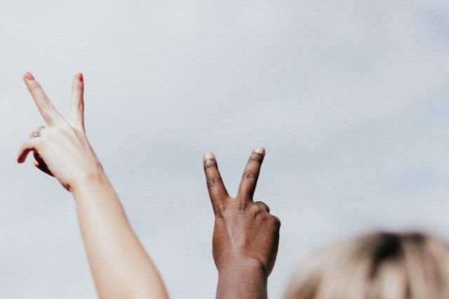 two-hands-holding-up-peace-signs