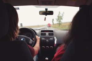 two-people-in-front-seat-of-car