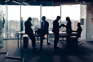 silhouetted-people-in-suits-in-office-building