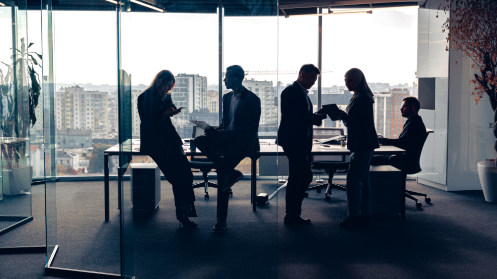silhouetted-people-in-suits-in-office-building