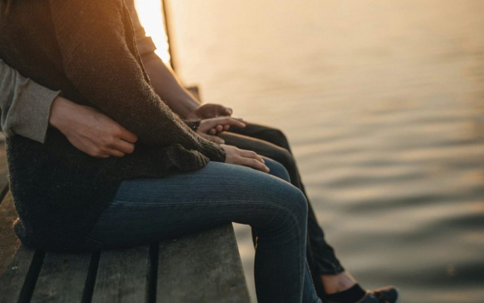 couple-sitting-on-pier