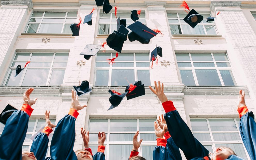 students-graduating-throwing-caps-in-air