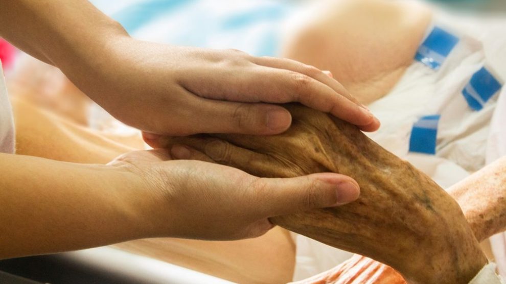 holding-elderly-persons-hand-in-hospice
