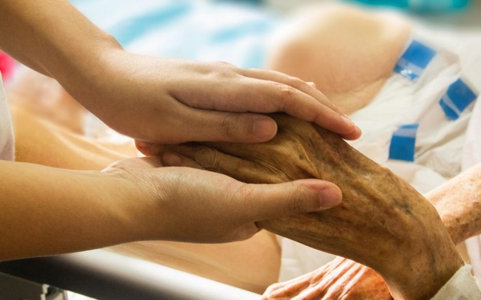 holding-elderly-persons-hand-in-hospice