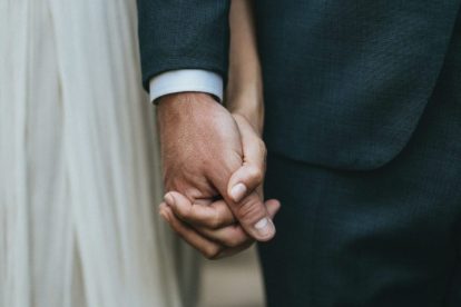 married-couple-at-wedding-holding-hands